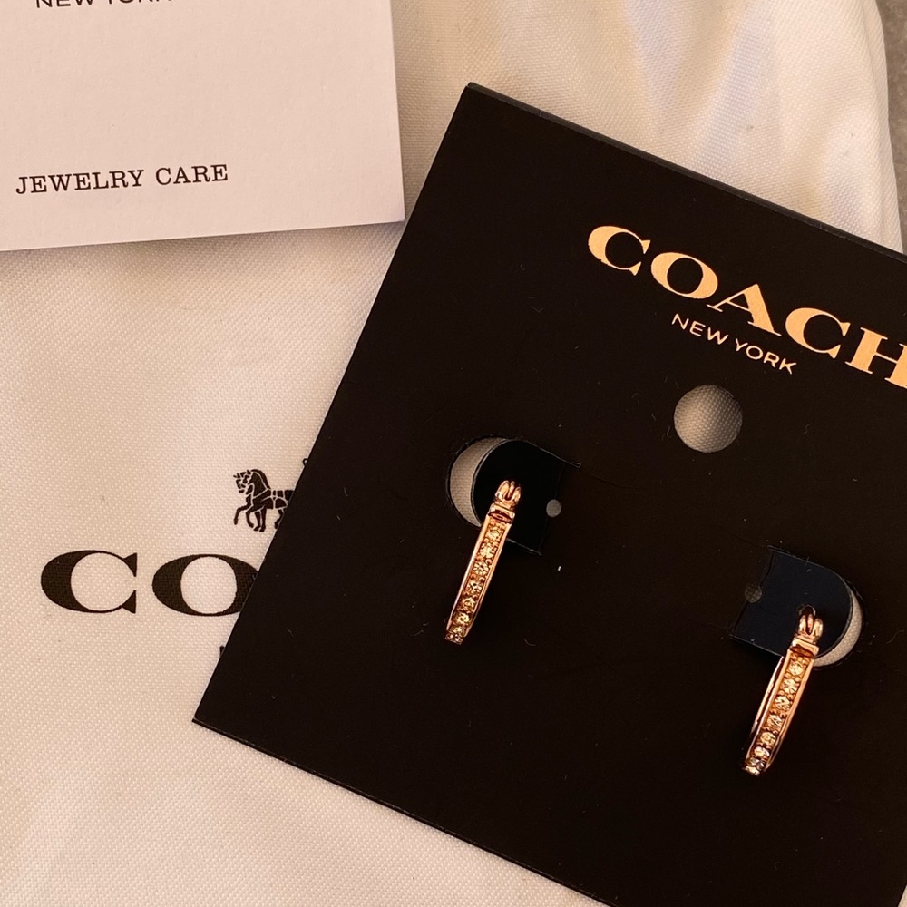 NWT. Rose gold coach huggie earrings